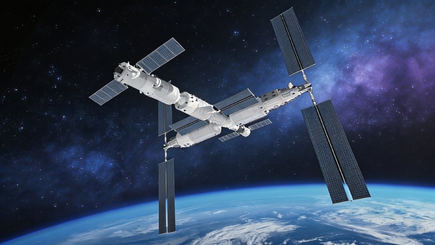 A large satellite with solar wings in orbit above the Earth